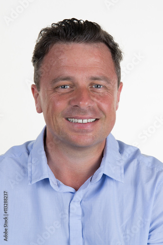 Mid adult businessman looking at camera with smiling and proud expression