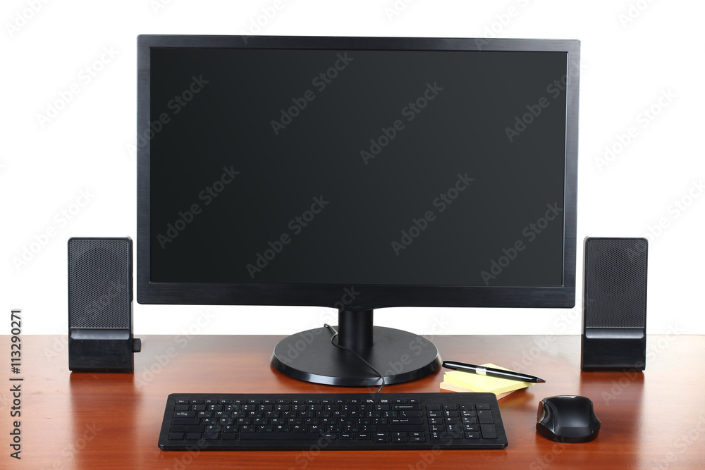 monitor with accessories and office items on a wooden table isolated on white background monitor with accessories and office items on a wooden table isolated on white background