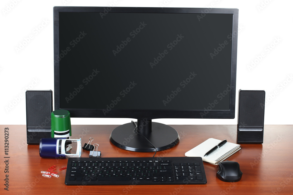 monitor with accessories and office items on a wooden table isolated on white background monitor with accessories and office items on a wooden table isolated on white background