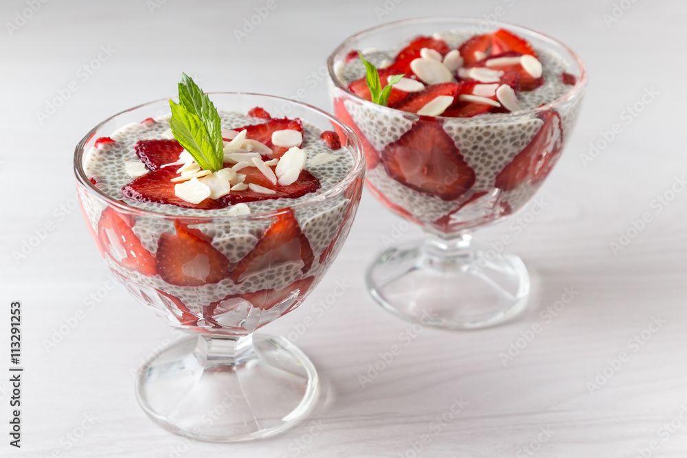 Raw vegan dessert: Chia seeds pudding with strawberries on a light background Raw vegan dessert: Chia seeds pudding with strawberries on a light background