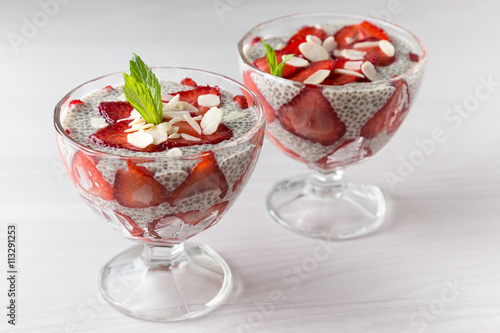 Raw vegan dessert: Chia seeds pudding with strawberries on a light background