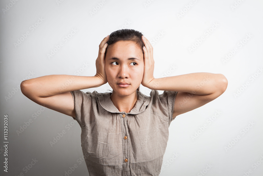 Asian woman with closed ears like stress and don't want to listen Asian woman with closed ears like stress and don't want to listen