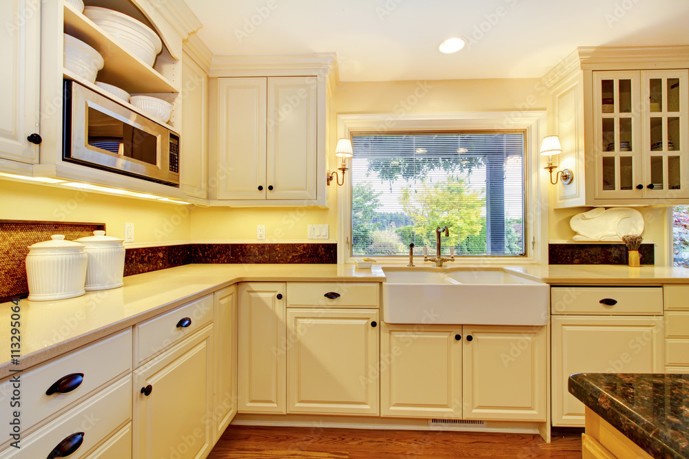 Cream color kitchen with large white sink and classic design. Cream color kitchen with large white sink and classic design.