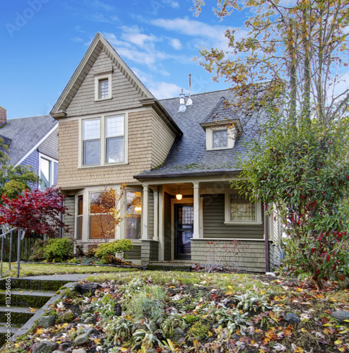 American Northwest home with front porch with railing and autumn
