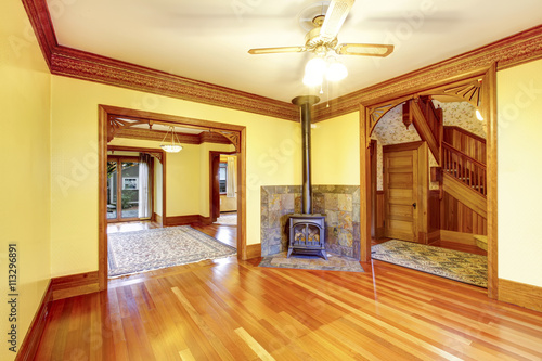 Unfurnished living room with fireplace, hardwood floor and paste © Iriana Shiyan