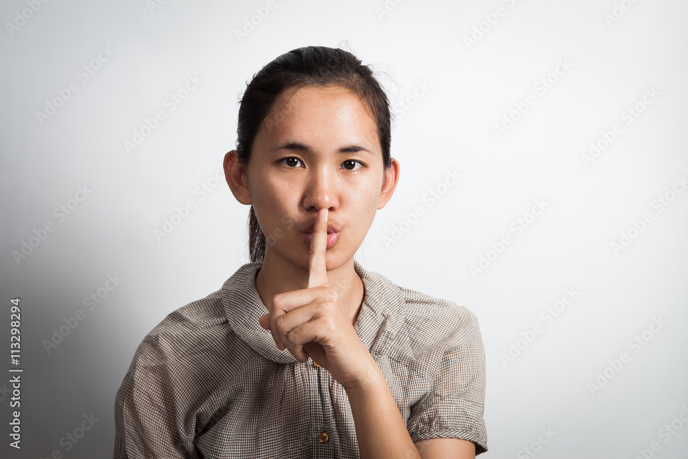 Asian woman finger on her lips. silence gesture. Asian woman finger on her lips. silence gesture.