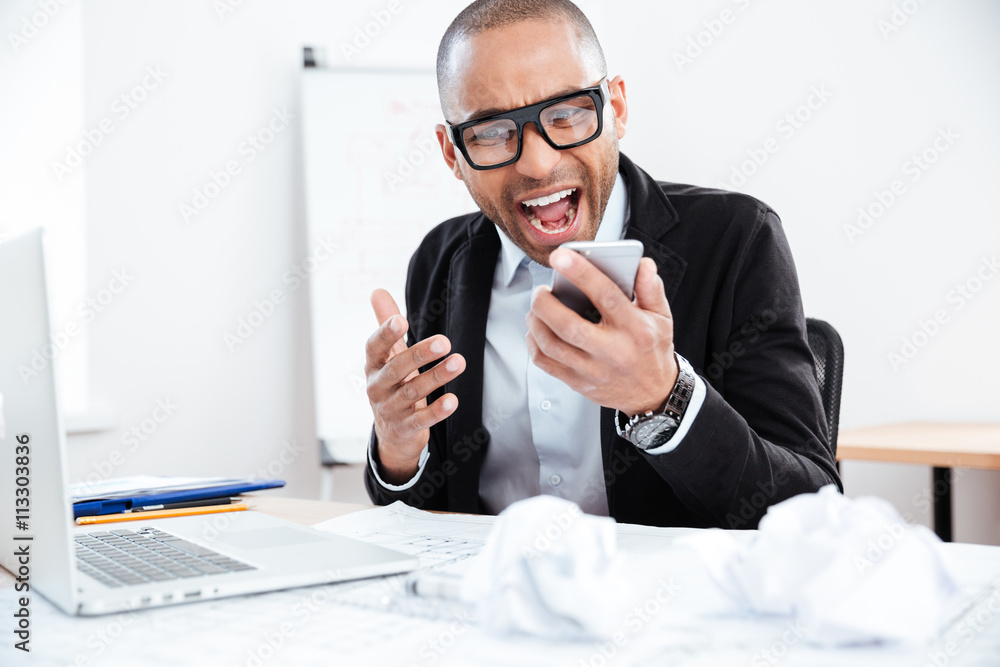 Close-up portrait of stressed businessman talking on mobile phone Close-up portrait of stressed businessman talking on mobile phone