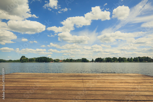  summer sky at lake landscape and wooden pier , vintage effect photo