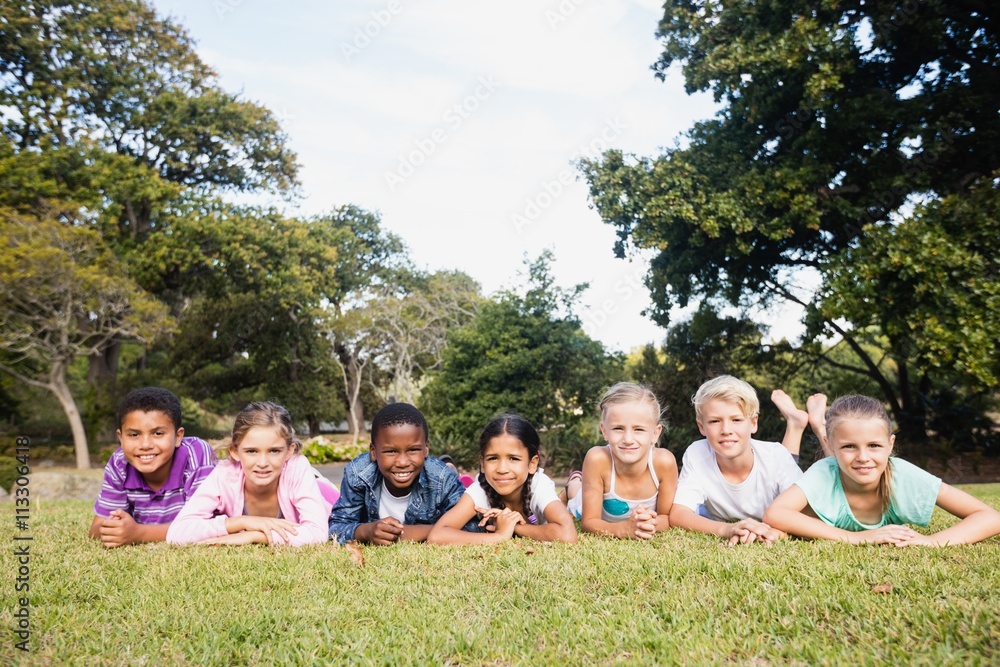 Smiling kids posing together during a sunny day Smiling kids posing together during a sunny day