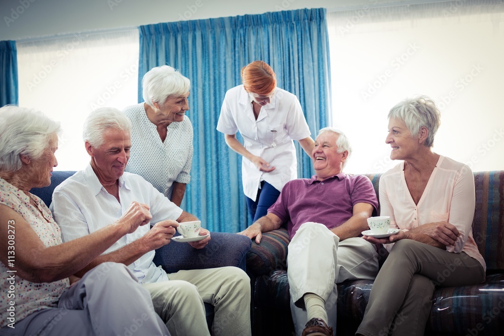 Fototapeta premium Seniors interacting with nurse