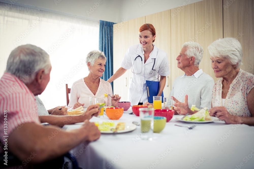 Pensioners at lunch with nurse Pensioners at lunch with nurse