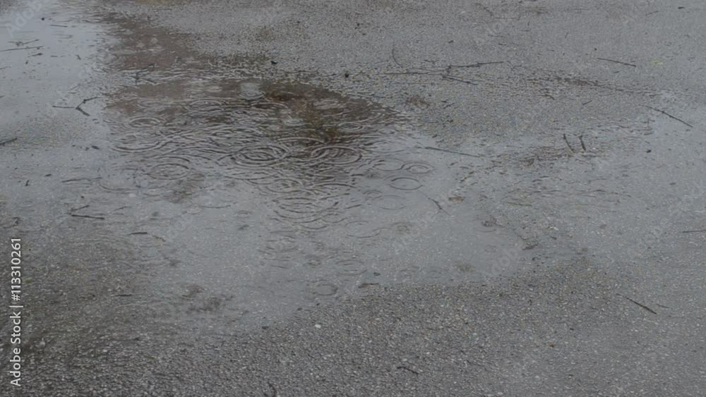 Water accumulation in puddle on asphalt surface during raining Water accumulation in puddle on asphalt surface during raining