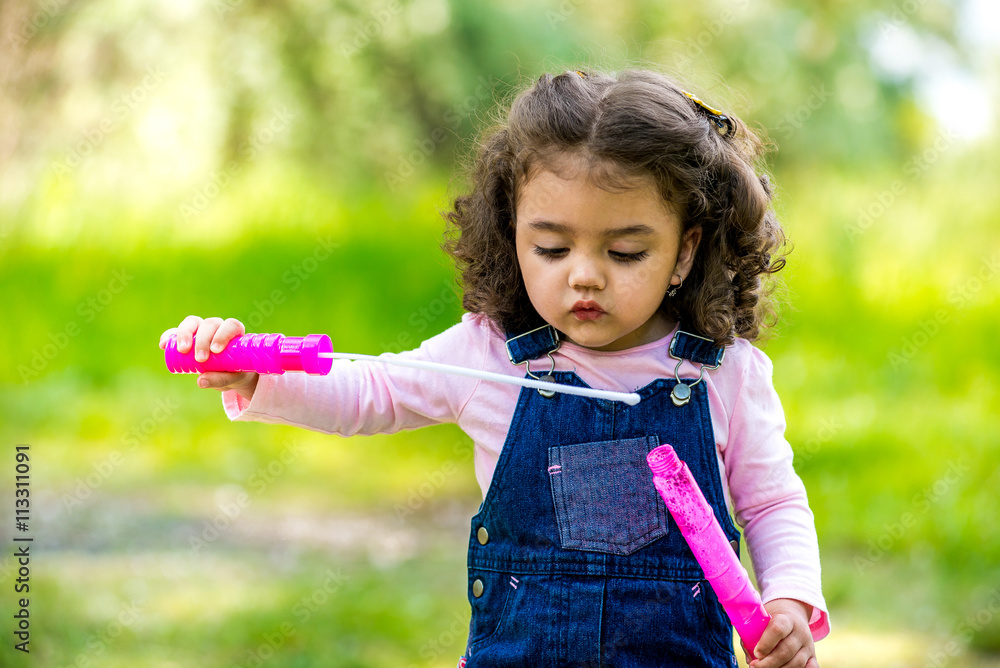 Portrait of cute girl blowing soap bubbles Portrait of cute girl blowing soap bubbles