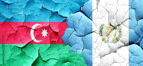Azerbaijan flag with Guatemala flag on a grunge cracked wall
