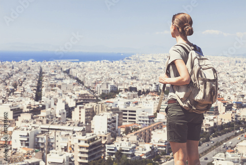 Traveler woman looking on a big city, travel and active lifestyle concept