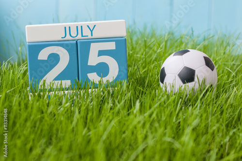 July 25th. Image of july 25 wooden color calendar on greengrass lawn background. Summer day  empty space for text