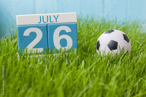 July 26th. Image of july 26 wooden color calendar on greengrass lawn background. Summer day  empty space for text