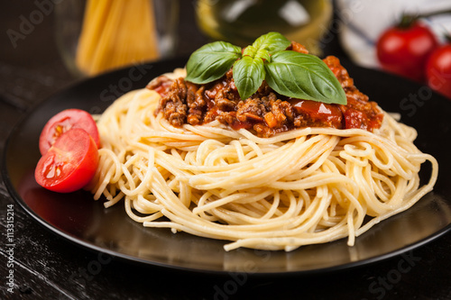 Spaghetti bolognese on dark background