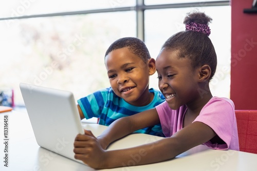 School african american kids using a digital tablet in classroom