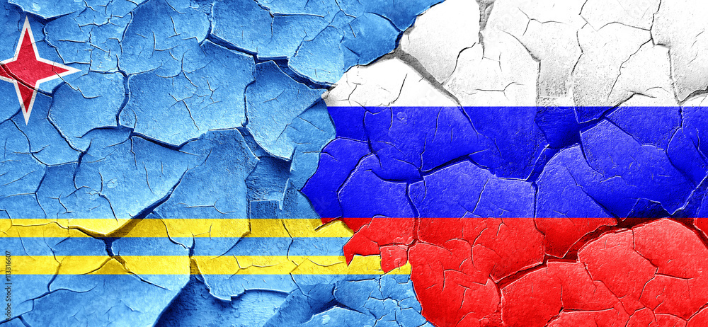 aruba flag with Russia flag on a grunge cracked wall