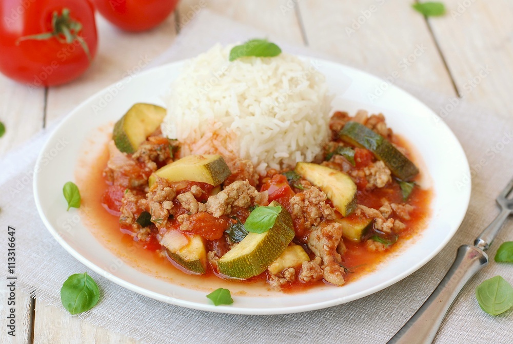 Spicy mincemeat with tomatoes, basil and zucchini with basmati rice