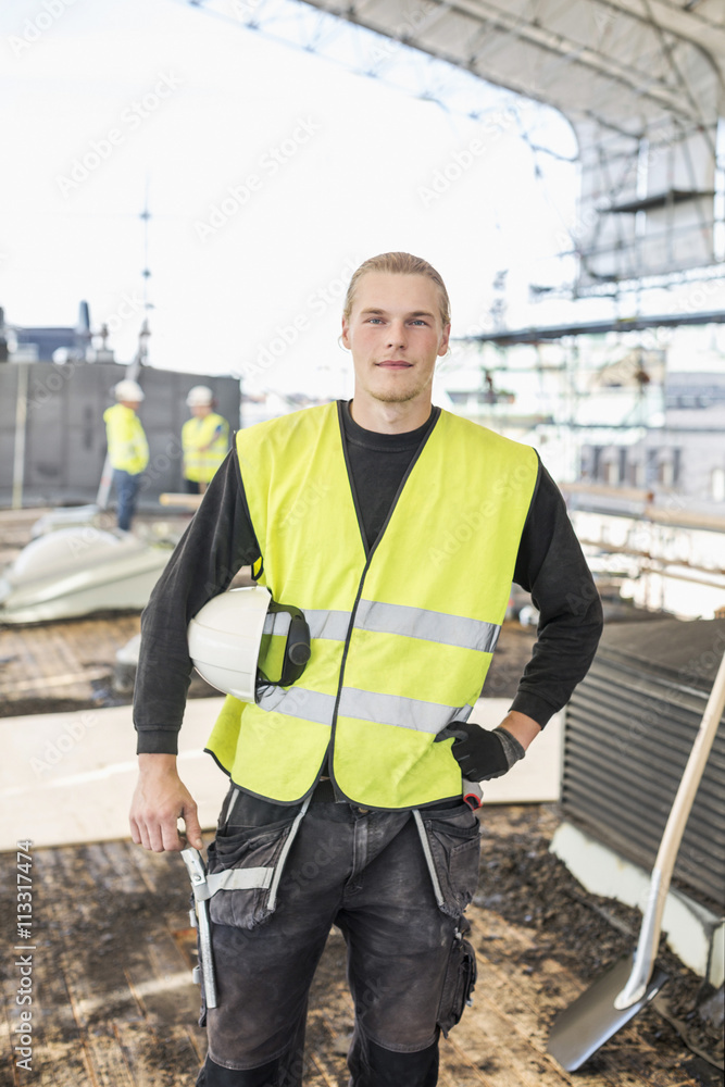 Portrait of confident construction worker standing at site Portrait of confident construction worker standing at site
