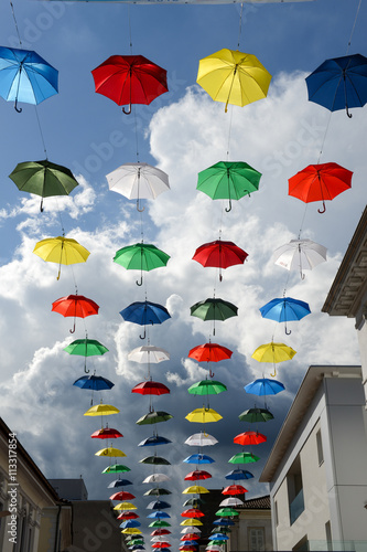 Many colorful umbrellas hanging on the pedestrian street of Chia