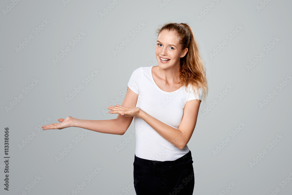 Smiling woman showing open hand palm with copy space Smiling woman showing open hand palm with copy space