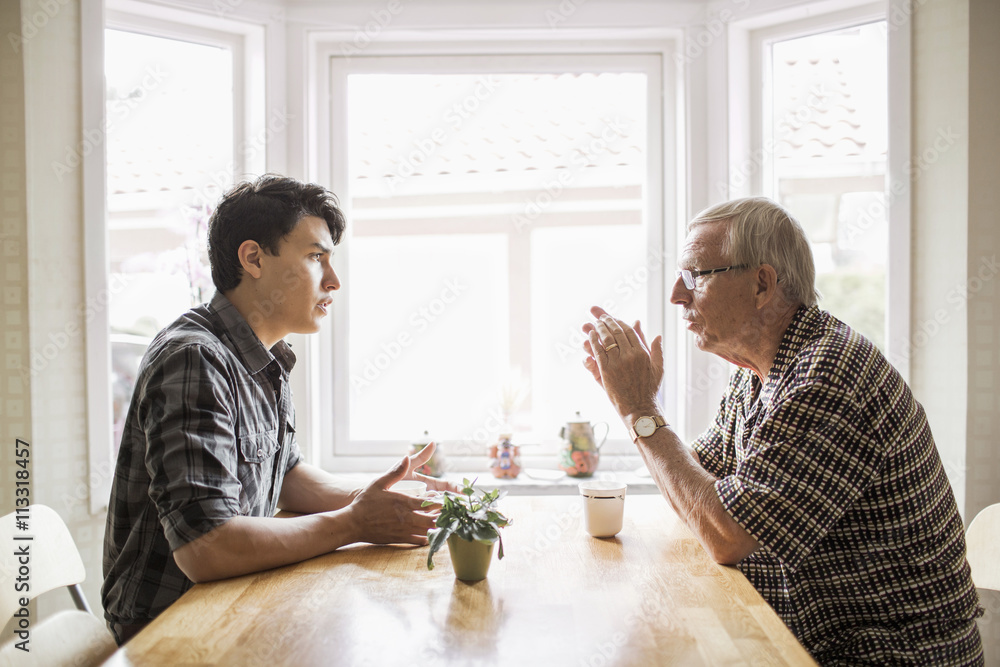 Two men talking at home Two men talking at home