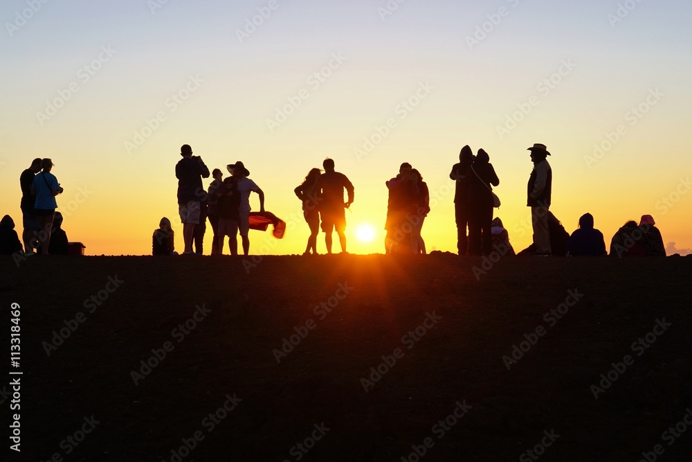 Silhouettes of people watching the sunset Silhouettes of people watching the sunset