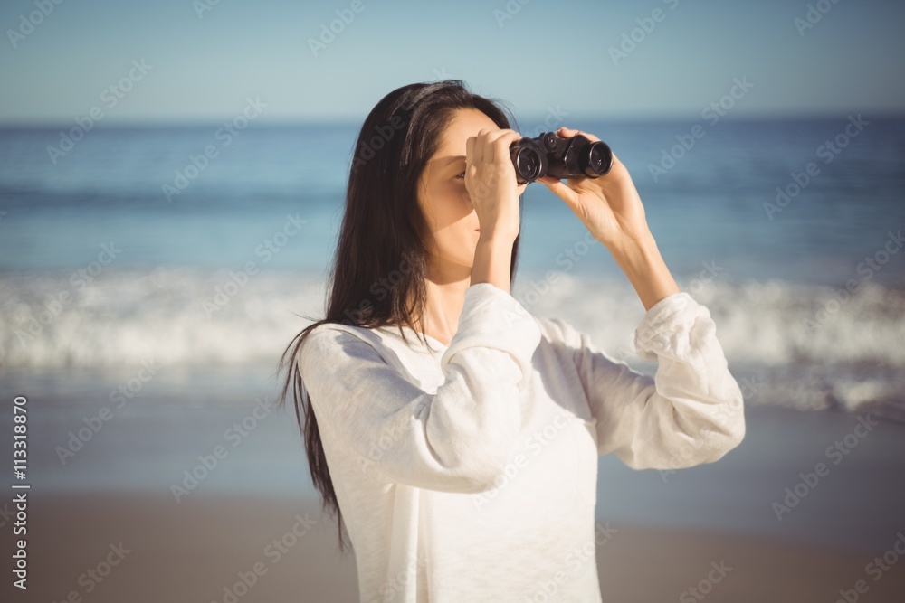 Woman looking through binoculars Woman looking through binoculars