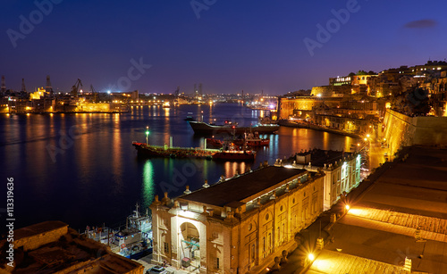 The night view of Grand Harbour with the cargo ships moored near