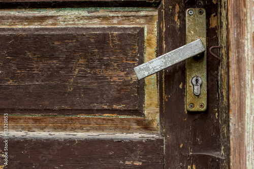 Old wooden door with rust handle