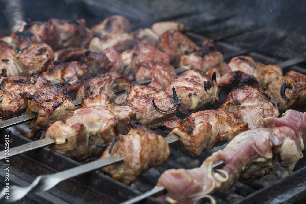 Juicy slices of meat on skewers prepare on fire shish kebab