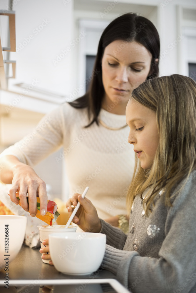 Mother and daughter cooking together Mother and daughter cooking together