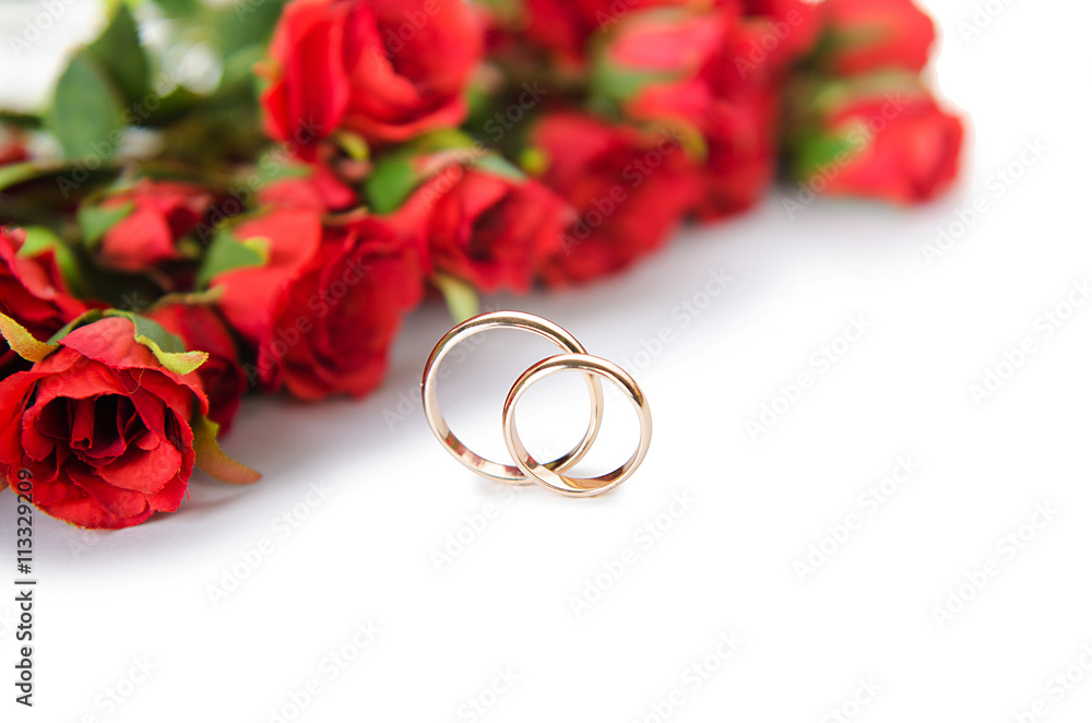 Wedding rings and flowers isolated on white background Wedding rings and flowers isolated on white background