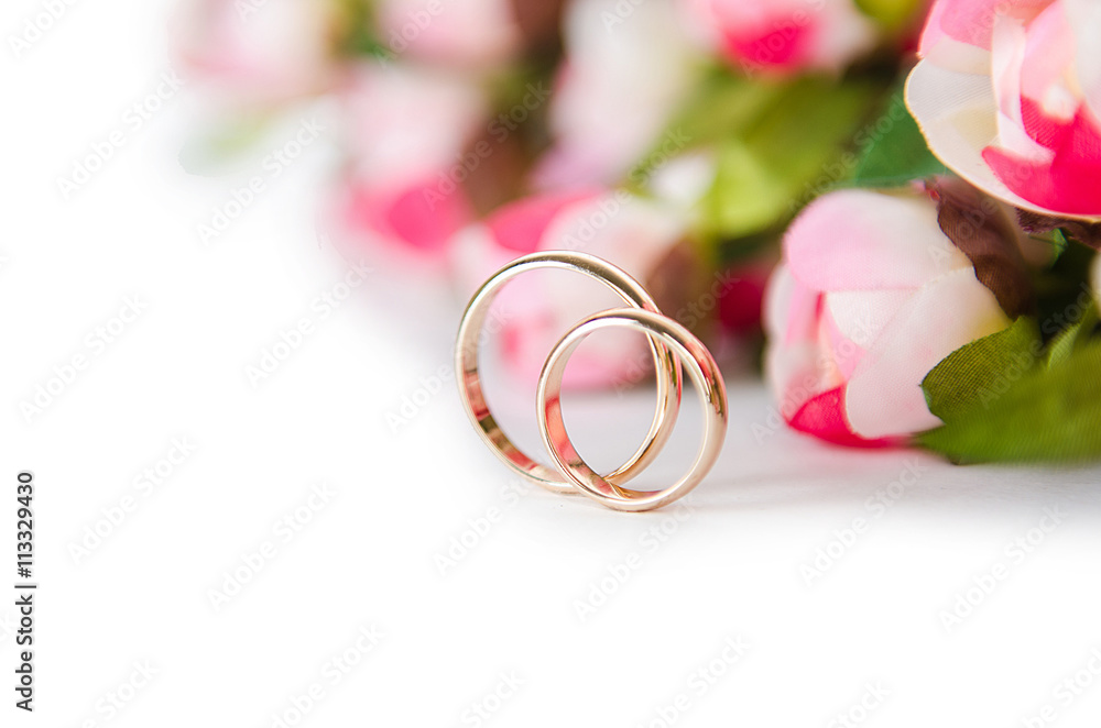 Wedding rings and flowers isolated on white background Wedding rings and flowers isolated on white background