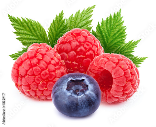 Three ripe raspberries with green leaf and one blueberry isolated on white background with clipping path