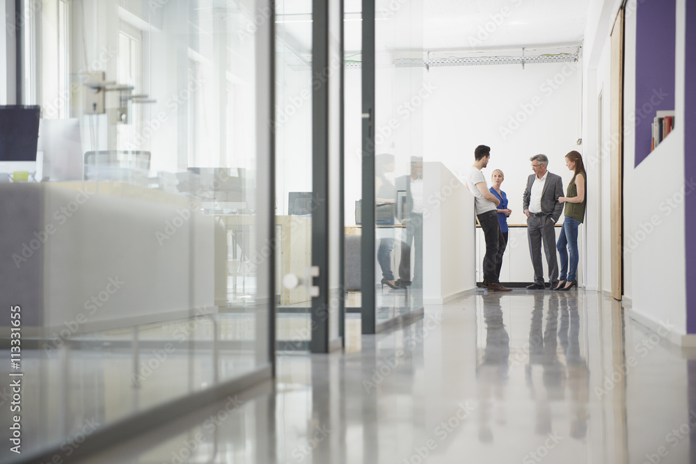 Group of business people meeting in office corridor Group of business people meeting in office corridor
