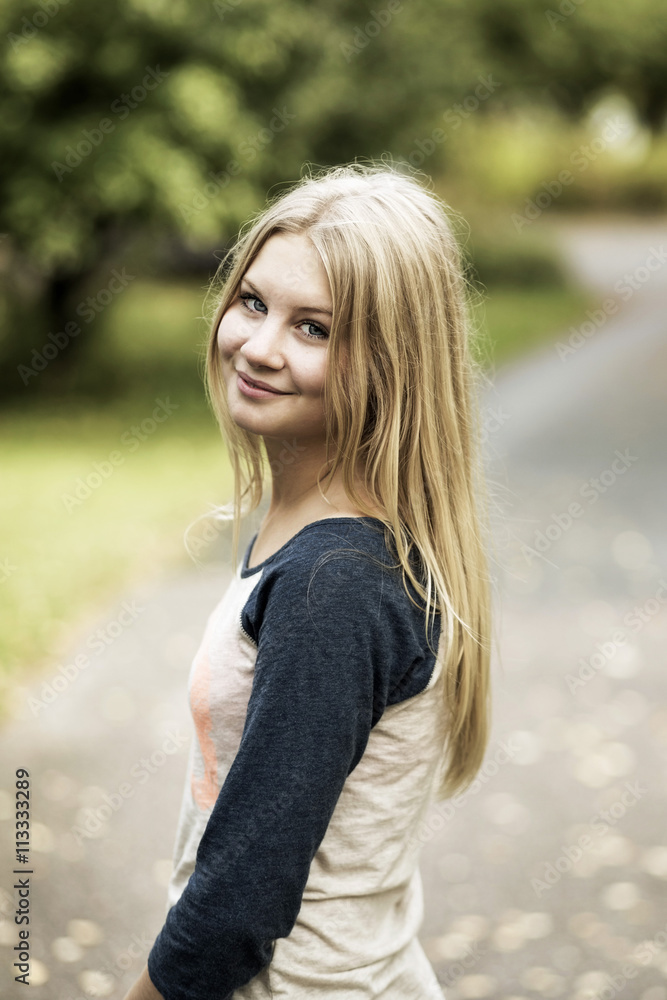 Portrait of smiling teenage girl standing on street Portrait of smiling teenage girl standing on street