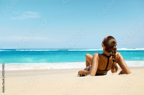 Woman On Beach In Summer. Sexy Happy Female Model Tanning