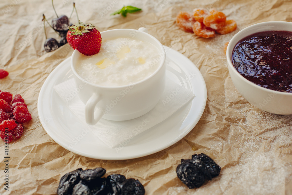 Rice porrige with strawberry on parchment background Rice porrige with strawberry on parchment background