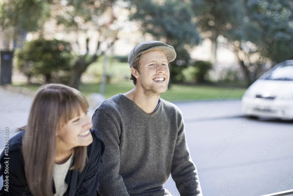 Happy couple sitting outdoors Happy couple sitting outdoors