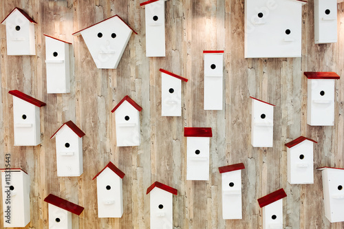 Fototapeta Birdhouses on the wall. Neighborhood and property concept