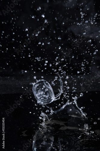 Ice cube flying with splashes on a black background #4