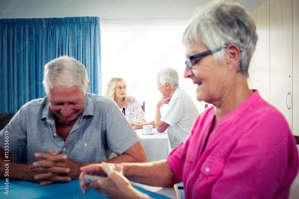 Group of seniors playing cards
