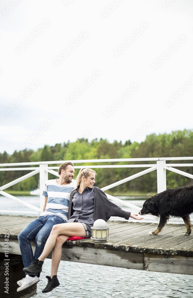 Couple with dog on pier Couple with dog on pier
