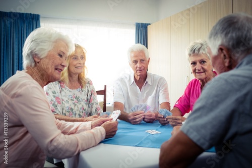 Group of seniors playing cards © WavebreakMediaMicro