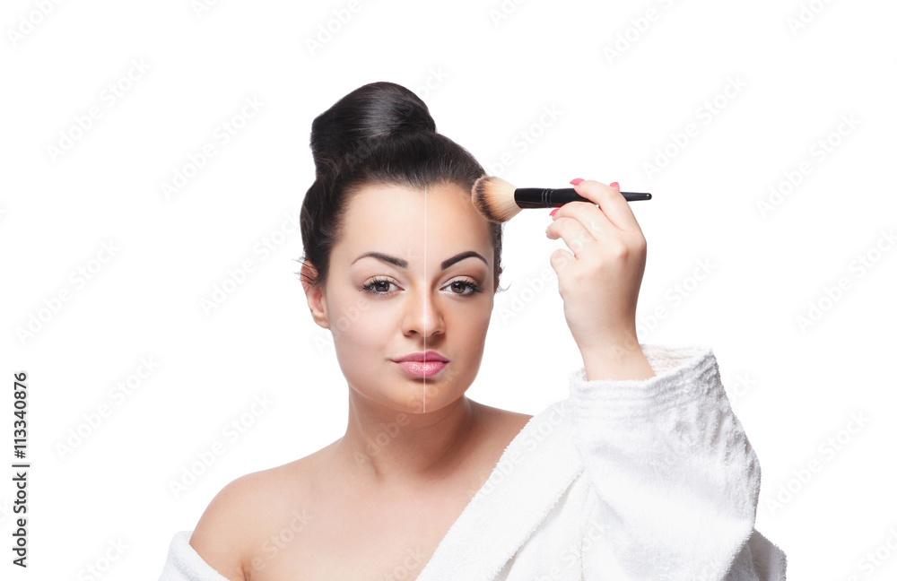 Beautiful woman finishing her makeup on half side of her face