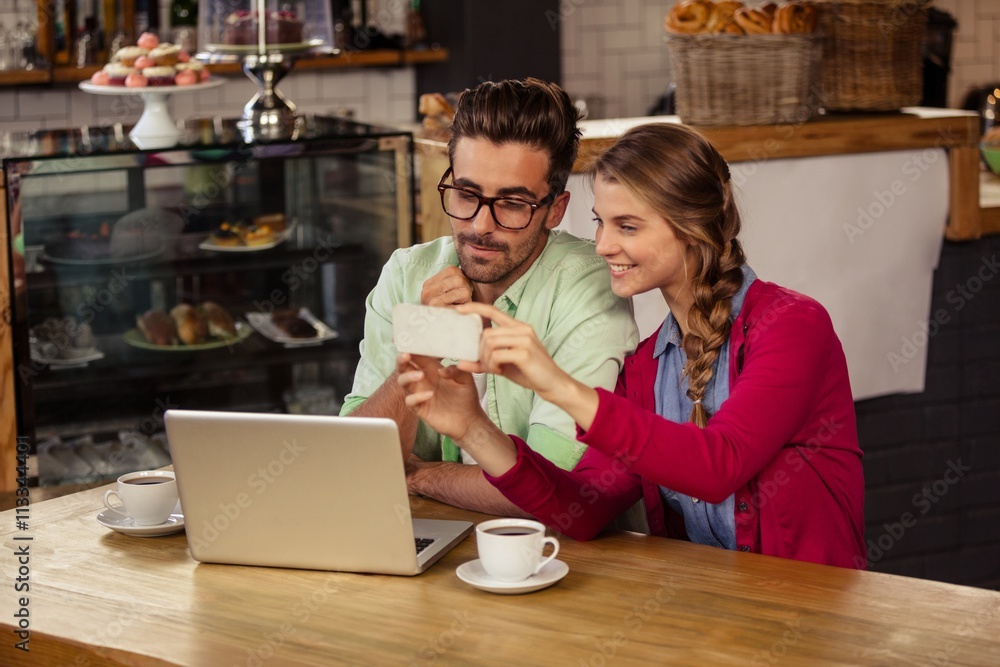 Two hipsters friends looking at smartphone Two hipsters friends looking at smartphone